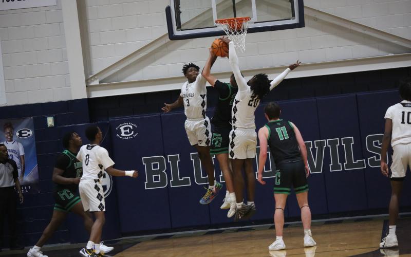 D.K. Winn (3) and Blu Hester (20) block a shot.  (Photo by Bo Underwood)
