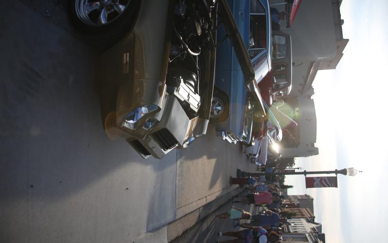 Spectators check out the classic cars on display during the Cruise-In Classic Car Show held on the downtown square in July. (File photo by Mark Wells)