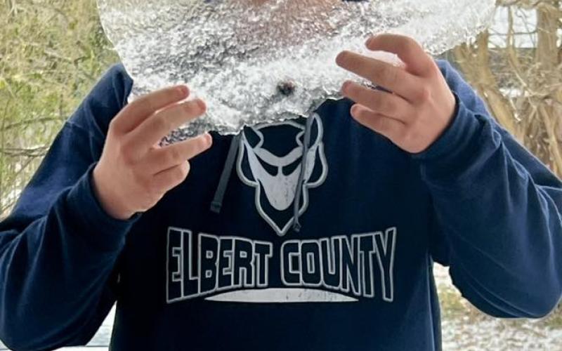 Elbert County resident Brock Dye holds a big chunk of ice in the aftermath of Winter Storm Fern. (Photo submitted by Melanie Dye)