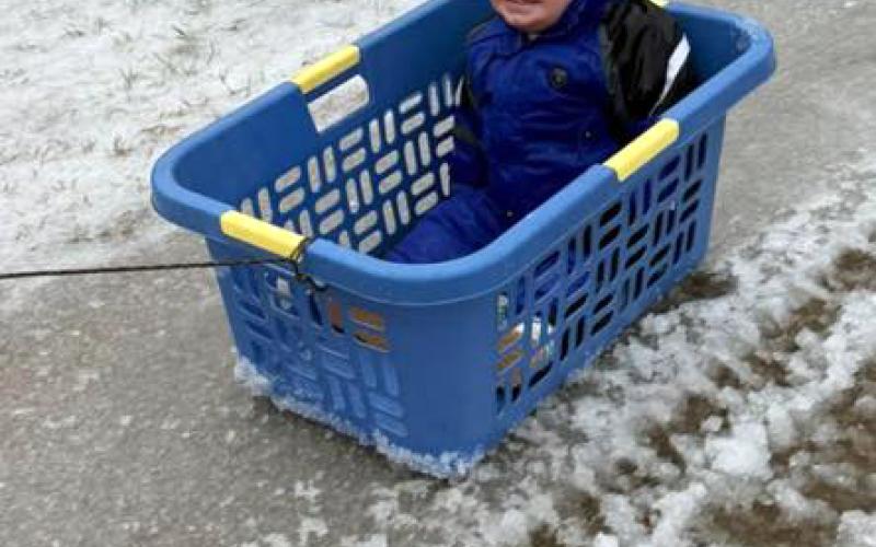 James Nestor uses a laundry basket as a sled. (Photo submitted by Heather Nestor)