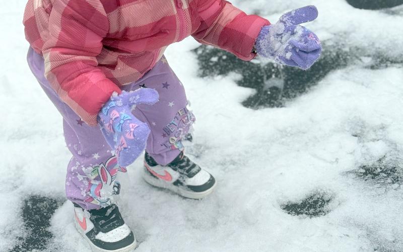 Aliani Owens looks at snow on her gloves after the winter storm. (Photo submitted by Brie Teasley)