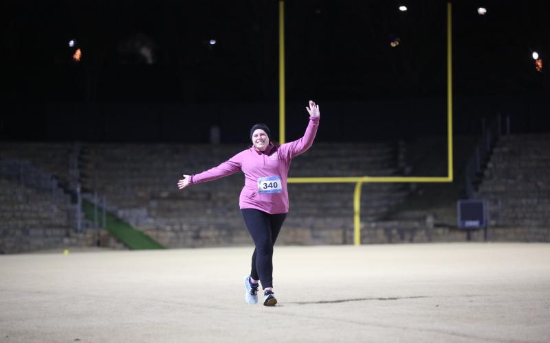 A woman runs in the Twilight Stroll by the Granite Bowl.