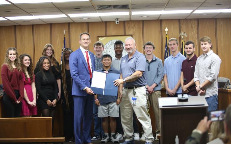Elbert County Comprehensive High School's JROTC Raiders were recently honored with a proclamation from the City of Elberton, honoring their national championship win in rope bridge in the 2025 All-Service Raider National Championships in November. Elberton Mayor Daniel Graves (front left) is pictured presenting the proclamation to JROTC Commander Lt. Col. J.D. Collie  (front right) and the rest of the rope bridge team.