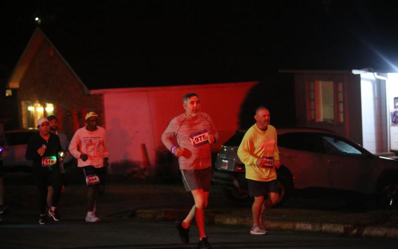 The neon lights were not too bright for the runners in the annual Twilight Stroll by the Granite Bowl Jan. 9. This year’s run was designated as a “glow run” and runners donned neon and fluorescent clothes and accessories to light up the night during the run. (Photos by Mark Wells)