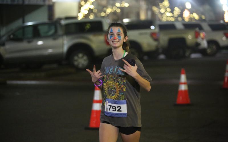 Kennedy Ray poses as she runs through the downtown square. (Photo by Mark Wells)