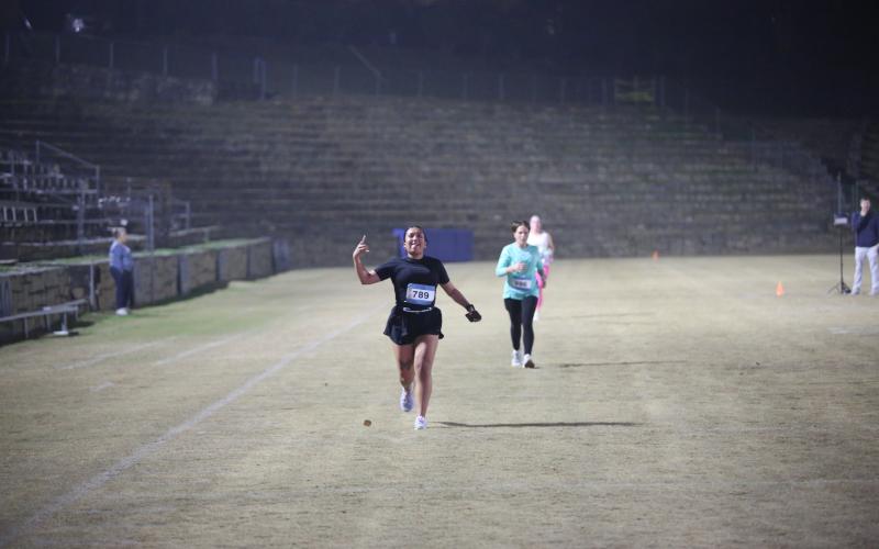 The neon lights were not too bright for the runners in the annual Twilight Stroll by the Granite Bowl Jan. 9. This year’s run was designated as a “glow run” and runners donned neon and fluorescent clothes and accessories to light up the night during the run. (Photos by Mark Wells)