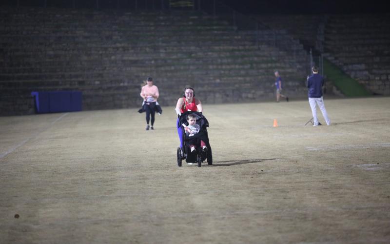 The neon lights were not too bright for the runners in the annual Twilight Stroll by the Granite Bowl Jan. 9. This year’s run was designated as a “glow run” and runners donned neon and fluorescent clothes and accessories to light up the night during the run. (Photos by Mark Wells)