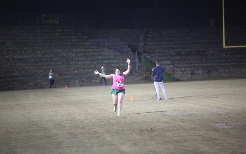 The neon lights were not too bright for the runners in the annual Twilight Stroll by the Granite Bowl Jan. 9. This year’s run was designated as a “glow run” and runners donned neon and fluorescent clothes and accessories to light up the night during the run. (Photos by Mark Wells)
