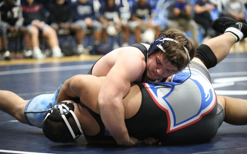 Lincoln Blackmon pins his opponent. (Photo by Mark Wells)
