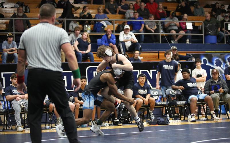 Jayden Thompson shoots for a doubleleg takedown in a match against Olgethorpe County. (File photo by Mark Wells)