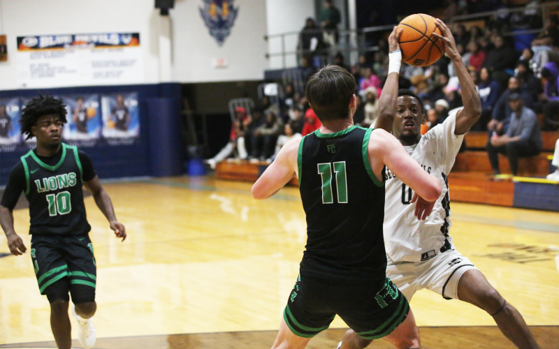 Jordan Morrison prepares to evade his defender at the basket. (File photo by Bo Underwood)