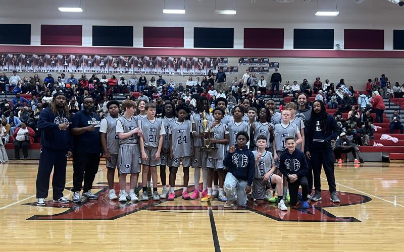 The Elbert County Middle School seventh grade boys’ basketball team poses after their win in the NEGIAA championship game. (Photo Courtesy of Derek Aston)