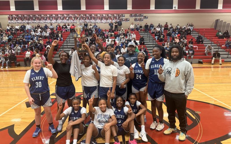 The Elbert County Middle School seventh grade girls’ basketball team celebrates after their win in the NEGIAA championship game. (Photo courtesy of Kathleen Newman)