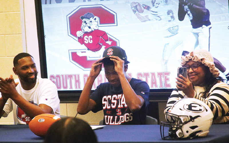 D.K. Winn puts his South Carolina State hat on after signing with the Bulldogs February 11, 2026. (Photo by Bo Underwood)
