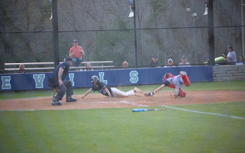 Dakota Toole (28) slides into home. (Photo by Bo Underwood)
