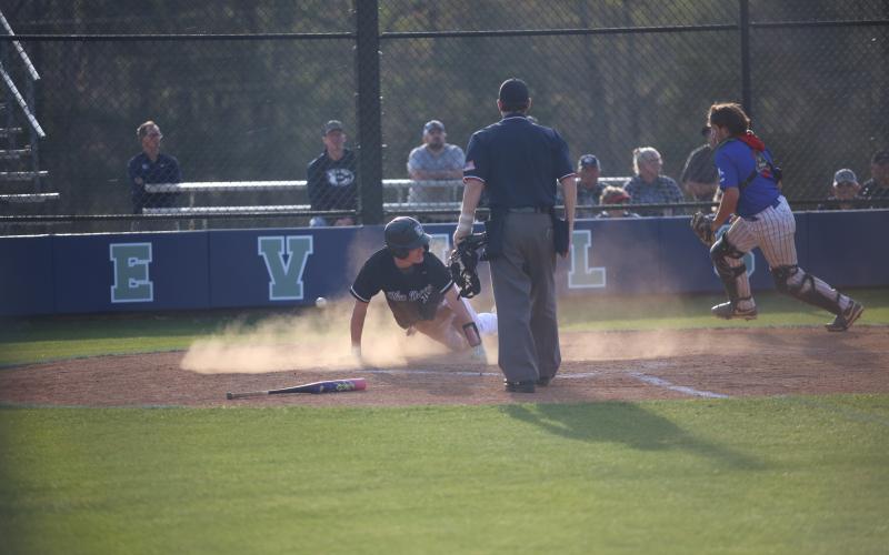 Brody Baker slides into home plate. (Photo by Bo Underwood)