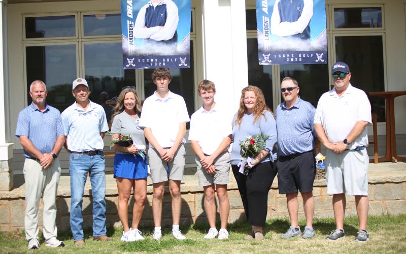 Madden Drake, Maddox Adams and family members pose alongside head coach Larry Kesler for senior day ahead of their April 2 match against Thomson. (Photo by Bo Underwood)