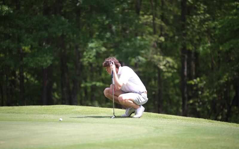 Landen Adams surveys the green at the 2026 Granite City Classic on Monday, April 13. The Elbert County boys’ golf team finished second overall at the 18-hole tournament at Arrowhead Pointe. (Photo by Bo Underwood)