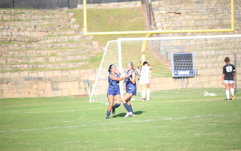 Seniors Kimberly Hernandez (left) and Jessica Flores (right) celebrate a goal. (Photo by Bo Underwood)