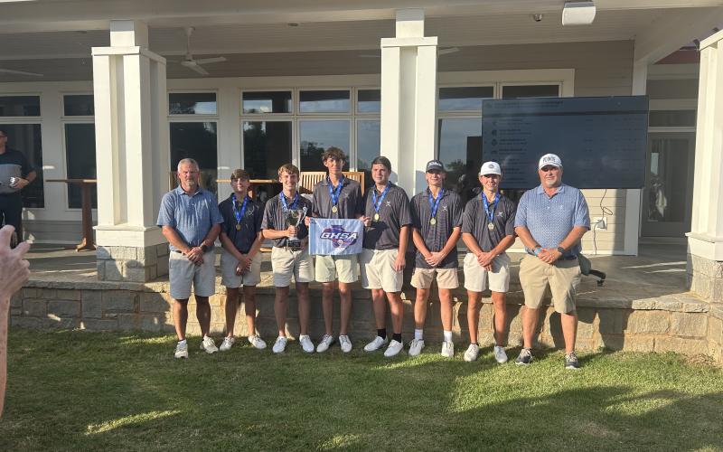 The Elbert County golf team (L-R), head coach Larry Kesler, Carson Amabile, Madden Drake, Landen Adams, Nolan Henderson, Ty Johnson, Maddox Adams and assistant coach Sandy Thornton won their second straight GHSA state championship Tuesday. (Photo by Bo Underwood)