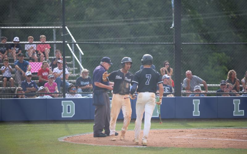 Jose Rodriguez celebrates a run with Jackson Black. Elbert County players throw up ‘devil horns’. (Photo by Bo Underwood)