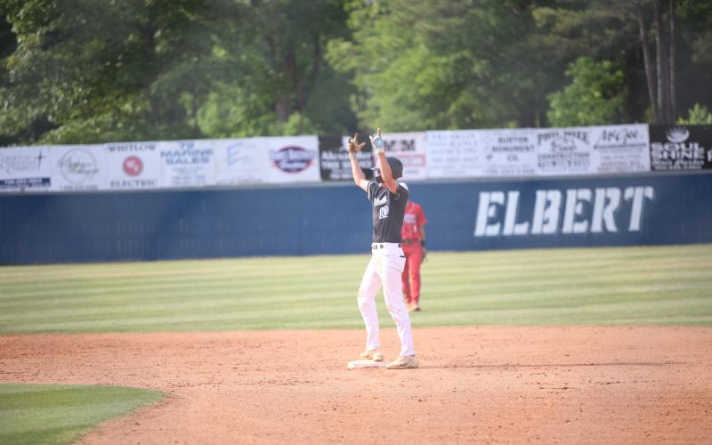 Brody Baker celebrates a double. Elbert County players throw up ‘devil horns’. (Photo by Bo Underwood)