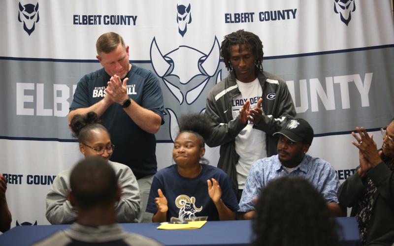 Kaylen Rucker, her family and coaches applaud after she signs her letter of intent to play basketball at Columbia International University. (Photo by Bo Underwood)