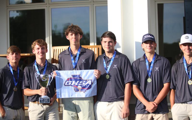 Madden Drake poses with teammates after Elbert County won the 2026 A Division I golf state championship. (Photo by Bo Underwood)