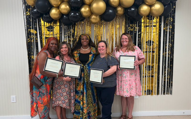 (L-R) Sandy Wingfield, Chrissy Fleming, Talyra Sims, Kelly Shea and Terri Jackson pose after a graduation ceremony for Sims' Mother to Mother Recovery Center, where Wingfield, Fleming, Shea and Jackson completed a 12-month course. (Photo by Mark Wells)