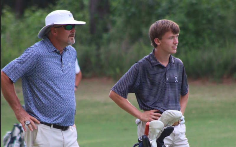 Larry Kesler stands with golfer Madden Drake. (Photo courtesy of Kellie Drake)
