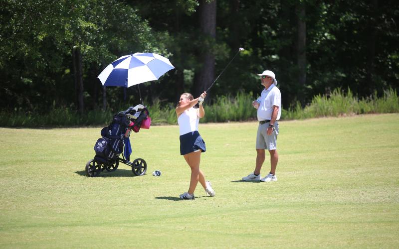 Elbert County golf coach Larry Kesler watches a shot from Lucy Johnson during the GHSA Class A Division 1 championship May 18. (Photo by Bo Underwood)
