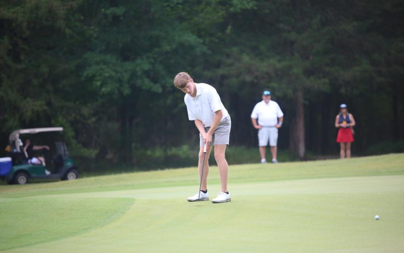 Madden Drake watches a putt on its way to the hole during the Class A Division 1 State Championship match. (Photo by Bo Underwood)