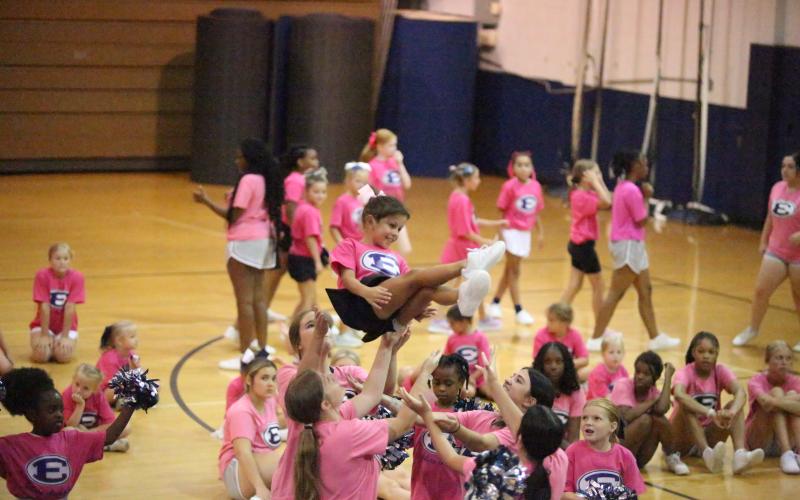 Ella Harrell is thrown through the air during cheer camp at Elbert County Comprehensive High School (ECCHS). A total of 82 future cheerleaders were in attendance for the camp put on by the ECCHS cheerleaders and coaches. (Photo by Bo Underwood)