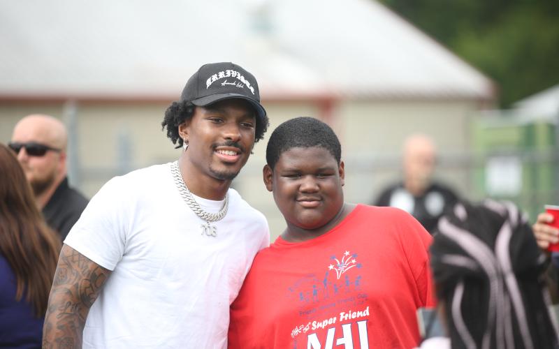 Mecole Hardman poses with a camper at last year's Friends Helping Friends Football Fun Day. (Photo by Mark Wells)