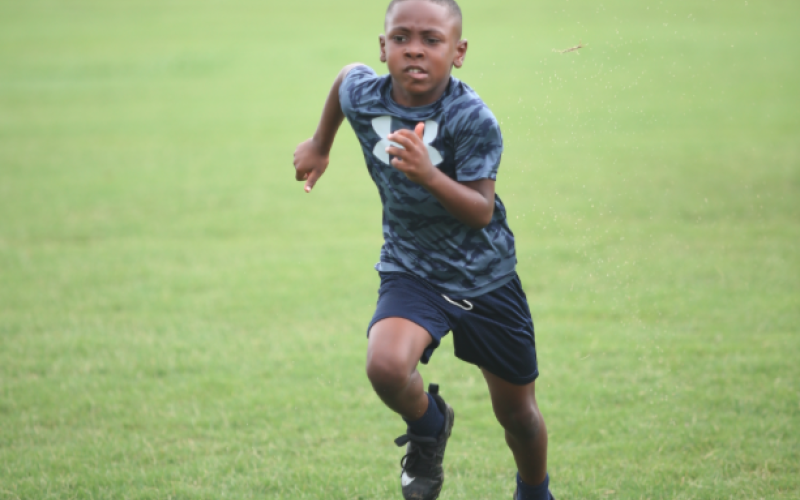 A child runs in the combine at last year's Friends Helping Friends Football Fun Day. (Photo by Mark Wells)
