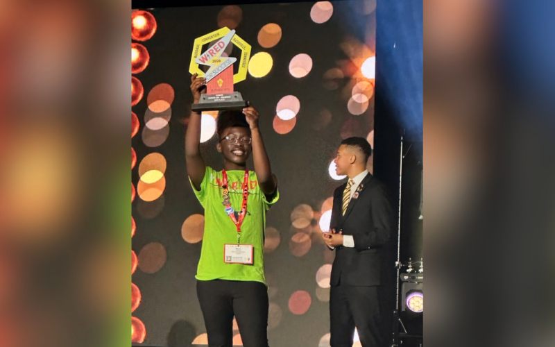 Alyssa Handy hoists her fifth-place award for on-site drawing during the National Junior Beta Convention in Nashville, Tennessee. (Photo courtesy of Marie Roach)