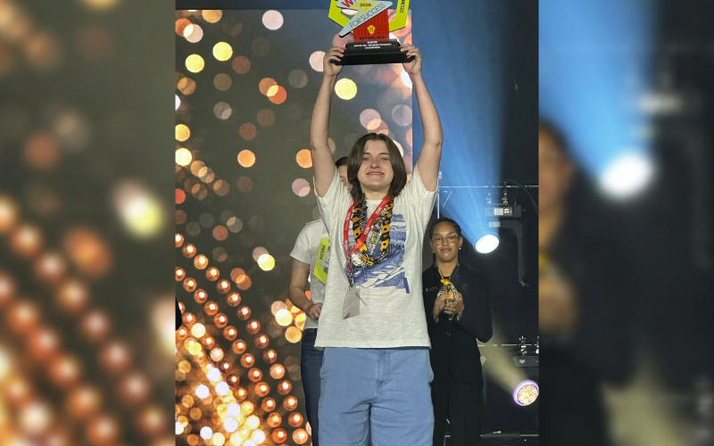 Elbert County’s Kaylee Harvey lifts her national championship trophy in the air. (Photo courtesy of ECCHS Beta Club)