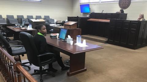 Savanna Marrie Jennings sits alone, handcuffed by Scott Franklin of the Elbert County Sheriff’s Office, shortly after a jury convicted her on seven charges, including malice murder and felony murder, in the death of Otha Perrin in 2018. She was also found guilty on two counts of aggravated assault, two counts of possession of a firearm or knife in the commission of a felony and concealing the death of another. (Photo by Jones)