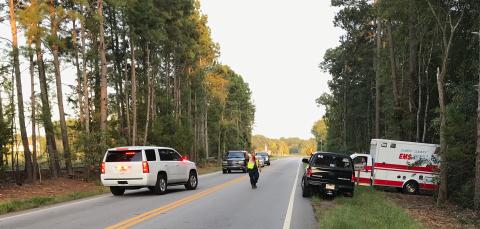 Elbert County personnel remove the body of a 51-year-old woman from a Bowman Highway residence early Sunday evening. (Photo by Jones)