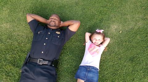 aking it easy is Elberton Police Capt. Darin Rucker (left) and a friend, Aspen Wright, who are relaxing after an event Rucker conducted as a part of the Elberton Police Department’s relationship-building efforts in the community.