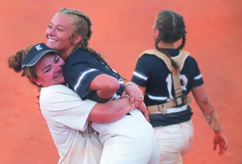Lady Blue Devil assistant coach Katie Archer (left) and senior pitcher Lauren Hart react during Elbert County’s 11-1 victory at Clarke Central High School  Sept. 4 in Athens (Photo by Cary Best)