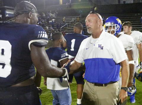 Washington-Wilkes offensive line coach and former Elbert County head coach Sid Fritts (right) shakes hands with senior Blue Devil Qwen Moss after Friday night’s game Aug. 30 in Elberton. (Photo by Cary Best) 