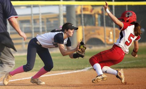 Junior Lady Diamond Madelyn Dias (left) tags Lady Redskin Cara Mayfield in the fifth inning of Elbert County’s 3-2 Region 8-AA win over Social Circle Sept. 12 on King Field in Elberton. (Photo by Cary Best) 