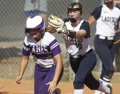 Lady Diamond Devil freshman shortstop Lilly Ray (right) tags out Lady Purple Hurricane Azure Guli during the first game of a region tournament doubleheader with Monticello Sept. 25 on King Field in Elberton. (Photo by Cary Best)