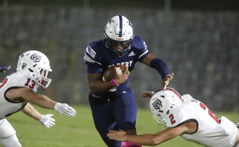 Blue Devil senior quarterback D.J. Ardister runs between two Wildcat defenders on his way to rushing for 63 yards and two touchdowns during Elbert County’s 52-15 loss to Rabun County Oct. 18 in Elberton.