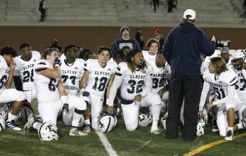Head football coach Brad Waggoner (left) delivers his last post-game speech of the season after Elbert County fell 48-21 to Frederick Douglass Nov. 16 at Lakewood Stadium in Atlanta.