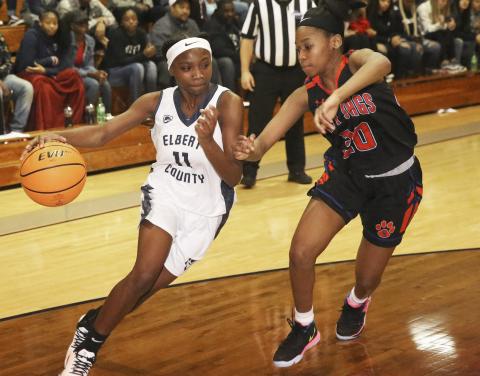 Freshman Lady Blue Devil point guard Terrace Hester (left) drives past Lady Jaguar Deneshia Roach in Elbert County’s 46-42 win over Cedar Shoals Dec. 20 in Elberton. (Photo by Dan Giles) 