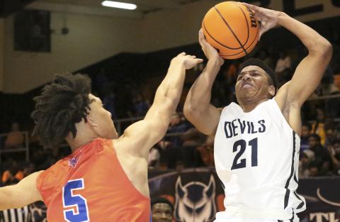 Blue Devil freshman guard Trustin Allen shoots over Jaguar Isaiah Sanchez in Elbert County’s 65-40 loss to Cedar Shoals Dec. 20 in the Inferno. (Photo by Dan Giles) 