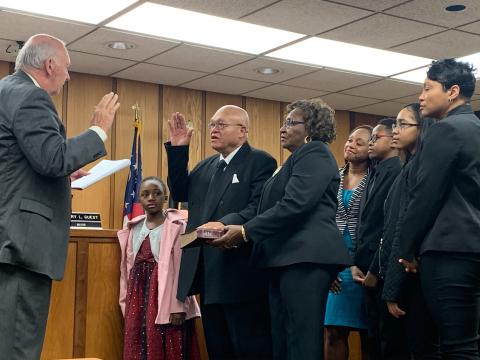 Terry Burton took his oath of office surrounded by his wife, two daughters and three grandchildren.