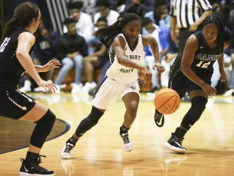 Lady Blue Devil freshman Terrace Hester (center) splits two Lady Leopard defenders during Elbert County’s 51-44 win over Banks County Jan. 24 in Elberton. (Photo by Dan Giles)